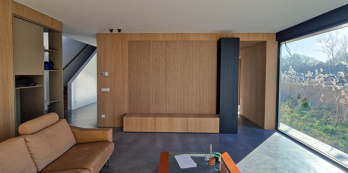 Maatwerk eikenhouten wandmeubel in een woonkamer